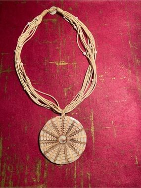 Handcrafted Cream Multi-Strand Necklace with Round Pendant
